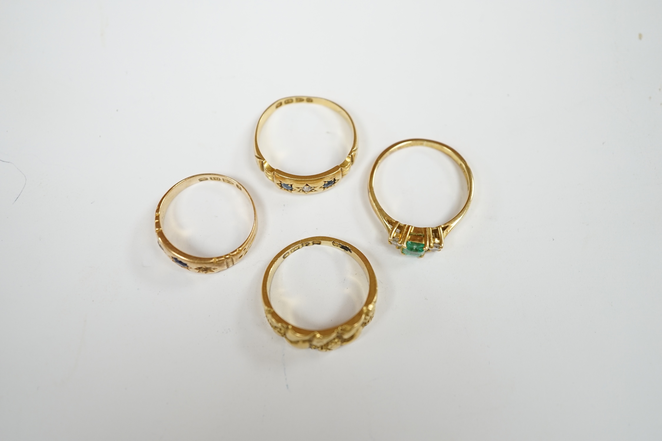 An Edwardian 18ct gold ring, size M, together with three other 18ct gold and gem set rings, including two early 20th century, gross weight 12.9 grams. Condition - fair